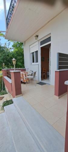 a house with a patio with a table and a balcony at Tranquil new apartmen7t in inland Lefkada in Spanokhórion