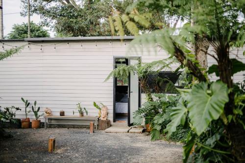 a white building with a bench in front of it at Dancasa Horse Farm & Homestay in Buôn Chiêt