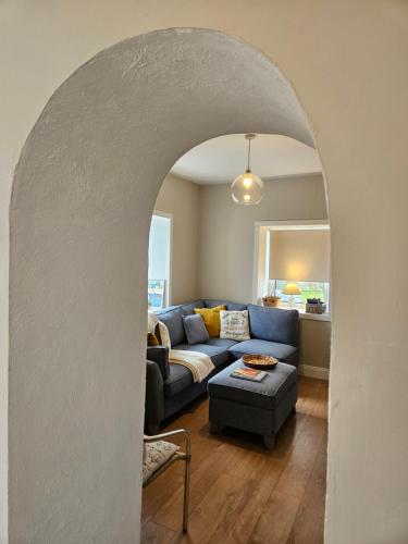 an archway in a living room with a blue couch at Achill Island Holiday home by the Sea in Achill Sound