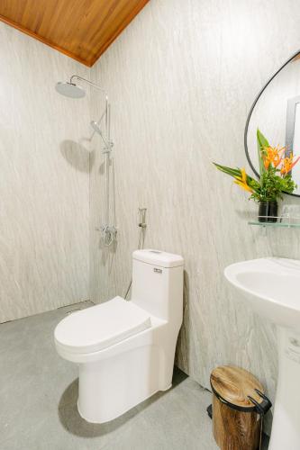a bathroom with a toilet and a sink at Dancasa Horse Farm & Homestay in Buôn Chiêt