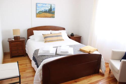 a bedroom with a large bed and a couch at Apalaches Trail House in Oleiros