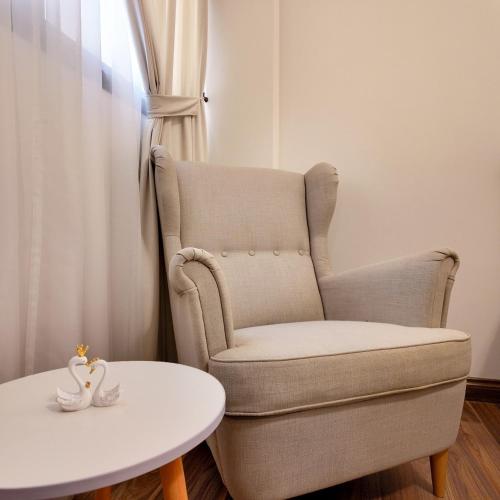 a room with a chair and a table and a white table at Sada Compound (Women Only) سيدات فقط in Riyadh