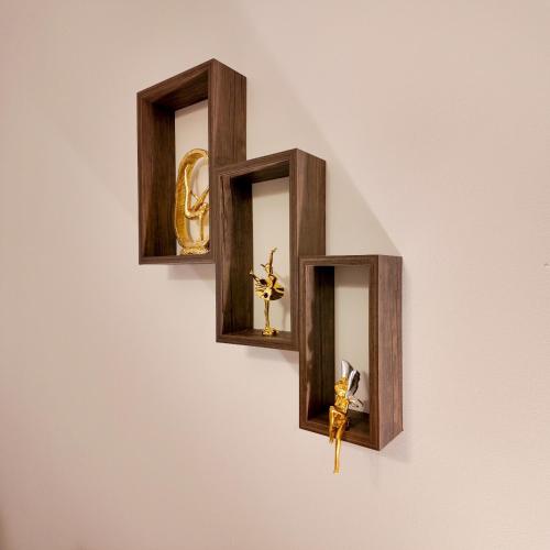 two wooden wall clocks on a white wall at Sada Compound (Women Only) سيدات فقط in Riyadh