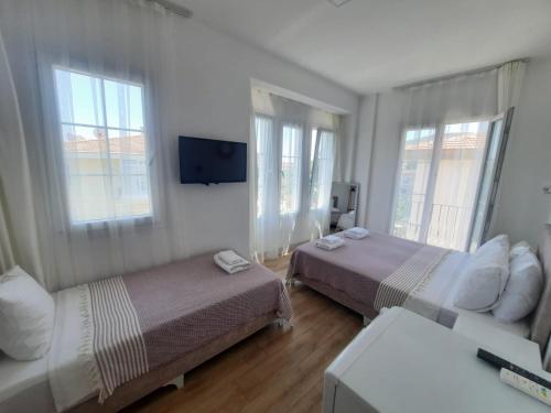 A bed or beds in a room at Adil Pansiyon