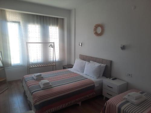 A bed or beds in a room at Adil Pansiyon