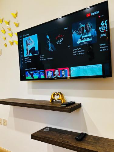 a flat screen tv hanging on a wall at Sada Compound (Women Only) سيدات فقط in Riyadh