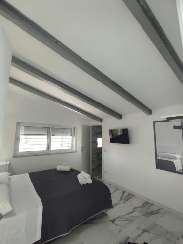 a bedroom with a bed with two towels on it at Lume Laura ROOMS in Capaccio-Paestum