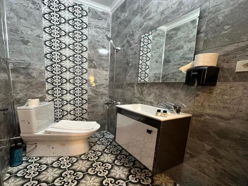 a bathroom with a toilet and a sink and a mirror at Kosova Hotel in Istanbul