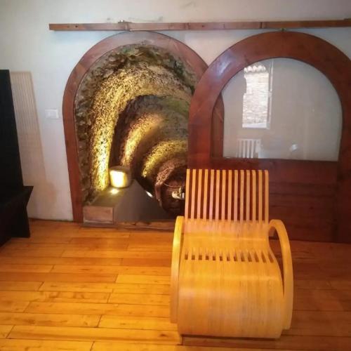 a wooden bench sitting in a room with a tunnel at La Torretta Historical Home in Casperia