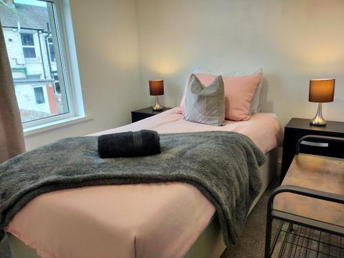 a bedroom with two beds with pillows and a window at Newly Renovated 3 Bedroom House, 6 beds with 2 showers, near University Town Centre in Lancaster