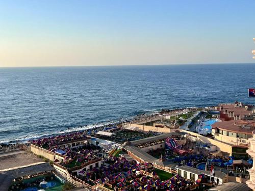 a crowd of people on a beach near the ocean at Ma Maison Gleem, Alexandria in Alexandria