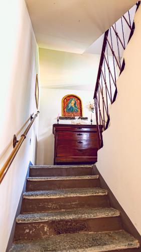 a set of stairs with a painting on the wall at Bello Lake Como Brunate in Brunate