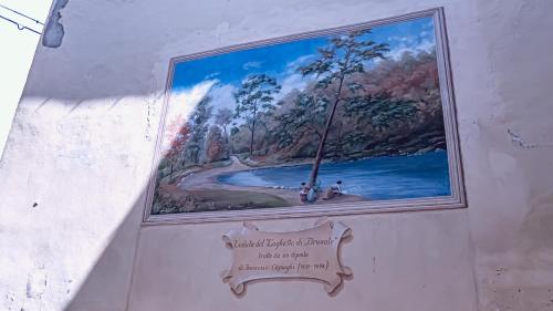 a painting on the side of a wall with a sign at Bello Lake Como Brunate in Brunate