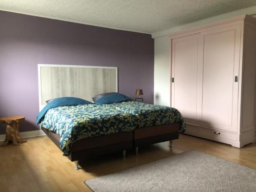 a bedroom with a bed with blue pillows at Wittlicher Monteuren - Ferienwohnung in Platten
