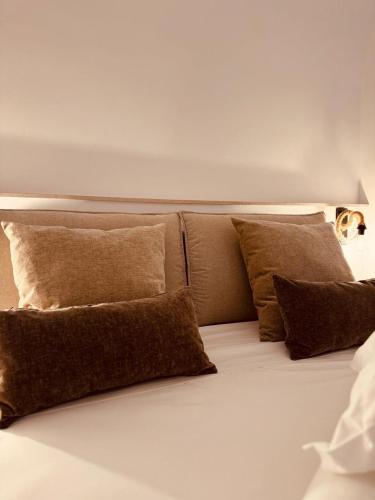 a bunch of pillows sitting on top of a bed at La dimora del faro in Bari