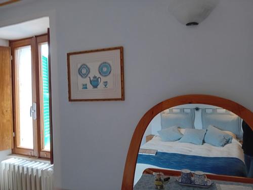 a bedroom with a mirror and a bed in a room at La Torretta Historical Home in Casperia