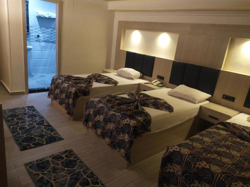 a hotel room with three beds and a bathroom at Havana Hotel Cairo in Cairo