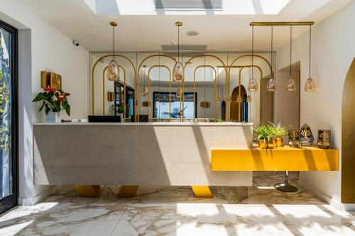 a lobby with a yellow bench and a reception desk at Cresanto Luxury Suites in Imerovigli