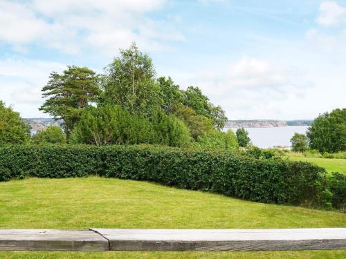 a park with a large hedge and a body of water at 6 person holiday home in KUNGSHAMN in Kungshamn