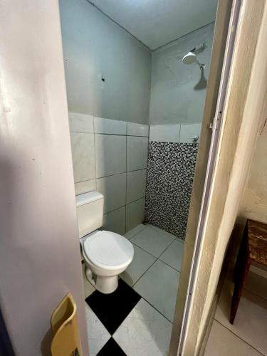 a small bathroom with a toilet and a shower at Recanto Canoa - Canoa Quebrada in Aracati