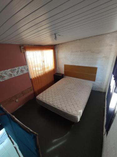 a small bed in a room with a window at Altos de Piriapolis2 in Piriápolis