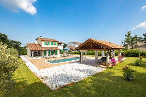 a backyard with a swimming pool and a gazebo at Villa Jozefina - Istria in Hreljići