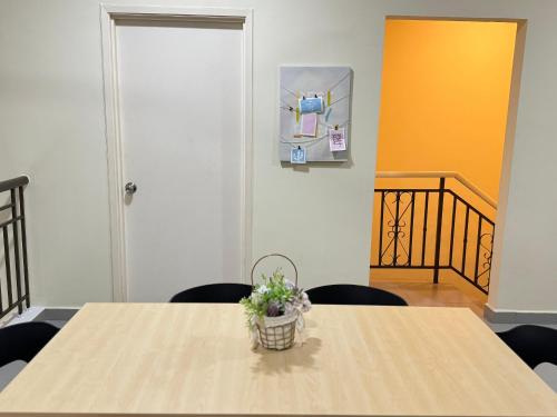 a table with a potted plant on top of it at Penthouse Desaru Beach 5G Wifi Netflix Pool View in Bandar Penawar