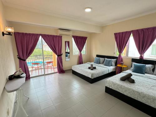 a living room with two beds and a couch at Penthouse Desaru Beach 5G Wifi Netflix Pool View in Bandar Penawar