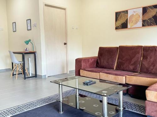 a living room with a couch and a table at Penthouse Desaru Beach 5G Wifi Netflix Pool View in Bandar Penawar