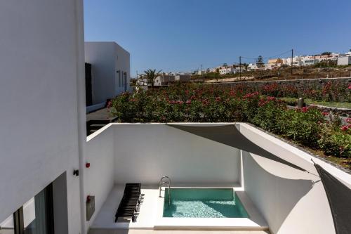 a swimming pool on the side of a building at Cresanto Luxury Suites in Imerovigli