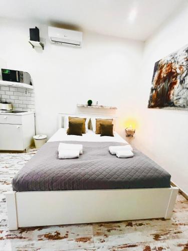 a bedroom with a bed in a white room at Comfy Luxury Apartment with 2 rooms in the City Centre AA in Budapest