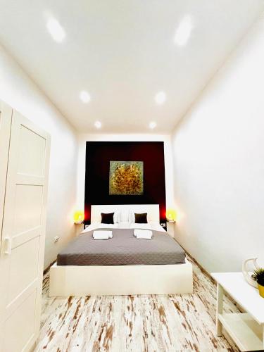 a bedroom with a bed and a painting on the wall at Comfy Luxury Apartment with 2 rooms in the City Centre AA in Budapest