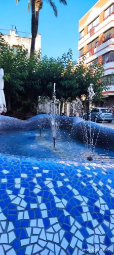 a fountain with a blue and white tile floor at HolaMar in Benicarló