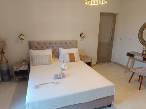 a bedroom with a large bed and a couch at VAYAL SKYROS in Skiros