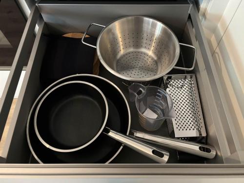 a drawer filled with pots and pans and utensils at Lindenhof Michaelis - Urlaub auf dem historischen Gutshof in Liebstadt