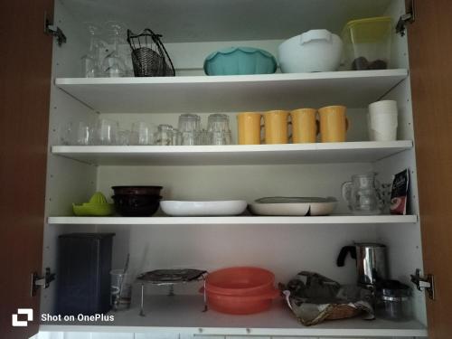a shelf with bowls and other items on it at Retro House in Savonlinna