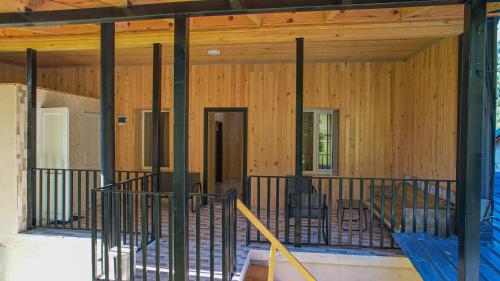 a screened in porch of a home with wooden walls at Givi Kakhiani's Svaneti Guesthouse in Zhabeshi