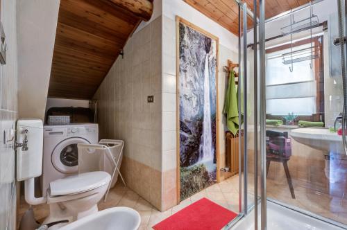 a bathroom with a toilet and a sink at Maison Zerbion Antagnod - Attic Charm Apartment Lounge and Garden CIR 0103 in Champoluc
