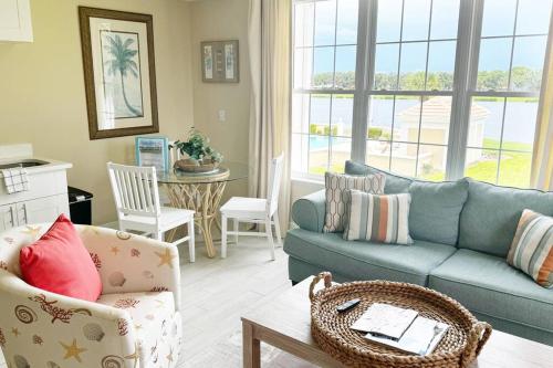 a living room with a blue couch and a table at Windsor Lodge Unit #19, studio close to beaches in Osprey