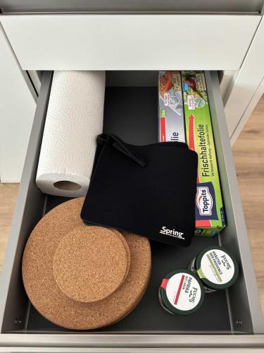 a drawer with a hat and other items in it at Lindenhof Michaelis - Urlaub auf dem historischen Gutshof in Liebstadt