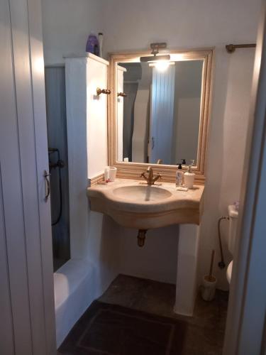 a bathroom with a sink and a mirror at Tinian View Bee Home Maisonette in Arnados