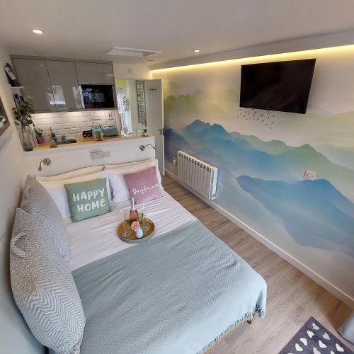 a bedroom with a bed with a wave mural on the wall at The Snug - Cosy Retreat for Two in Inverness