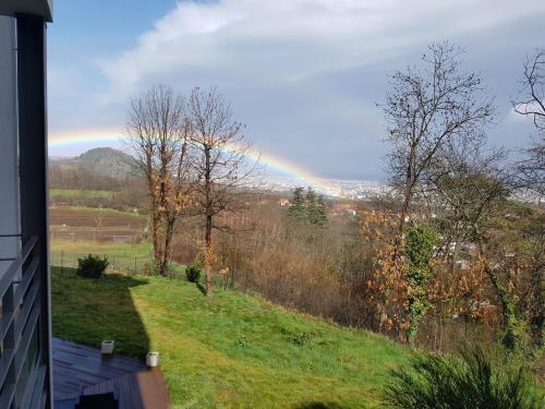 a rainbow in the sky over a field at Horizon Feng Shui - jardin, terrasse et vue in Ceyrat