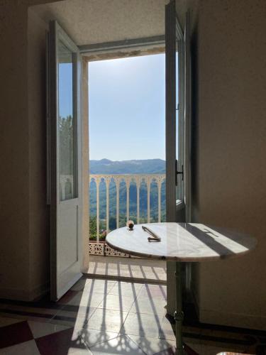 an open door to a balcony with a surfboard at La Dimora di Pindaro in Colledimacine