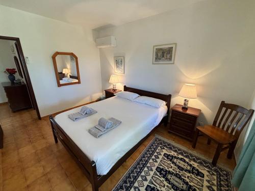 a bedroom with a bed and a mirror and a chair at Private 3 bedroom villa in Salema amazing views in Salema
