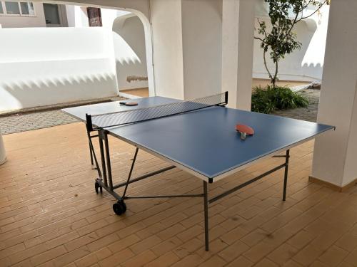 a ping pong table with a tennis ball on it at Private 3 bedroom villa in Salema amazing views in Salema