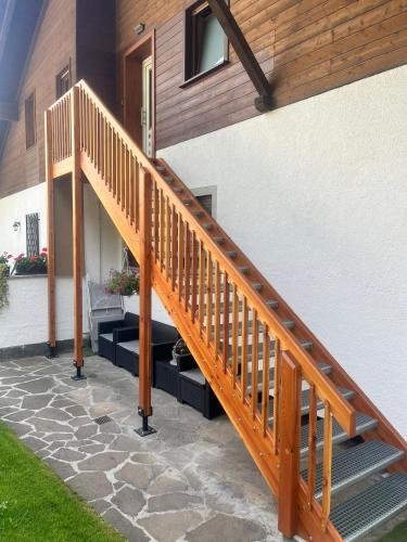 a wooden staircase leading up to a house at Stroblhof in Vipiteno