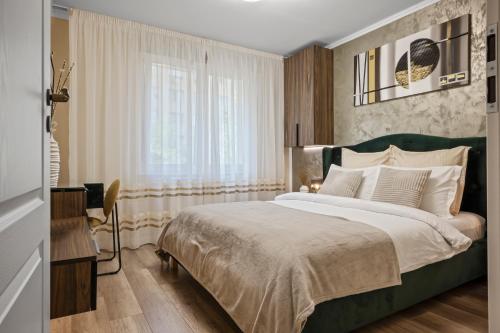 a bedroom with a large bed and a window at Awesome Apartment Bucharest in Bucharest