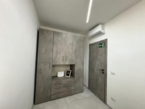 a room with a closet and a cabinet and a door at Casa vacanze Tramontana Salentina in Lendinuso