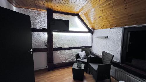 a living room with a large window and a tv at Chez Béné in Rochefort